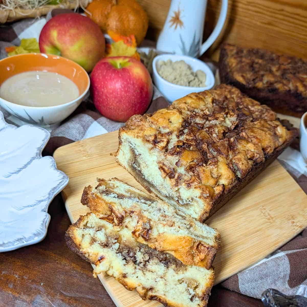 Sliced homemade apple cinnamon bread showing pieces of fresh apple inside.