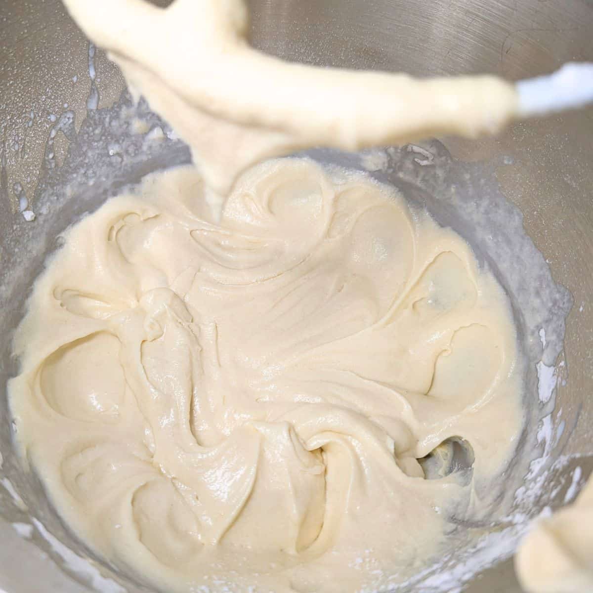 Ingredients mixed in a mixing bowl for cinnamon bread.