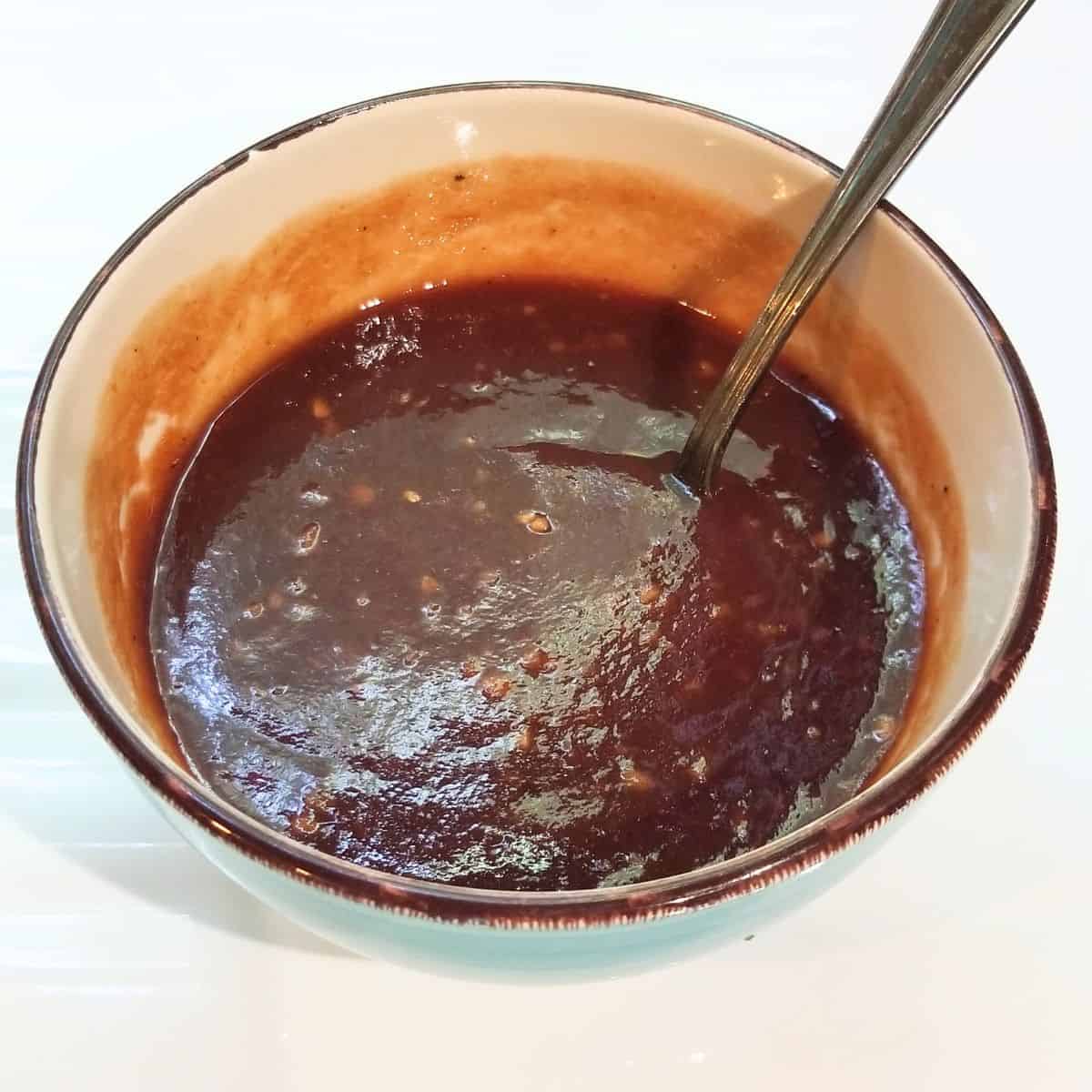 Homemade sweet and spicy barbecue sauce made with barbecue sauce, ketchup, honey, brown sugar, garlic, and chili garlic sauce.