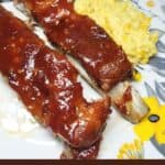 BBQ ribs on a serving plate with a side. Text overlay.