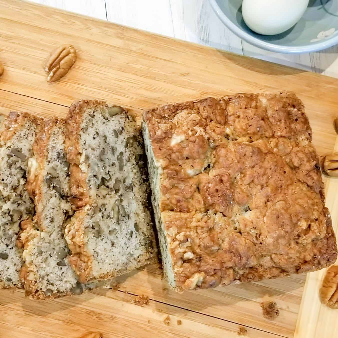 Banana bread on a wooden cutting board ready to serve.