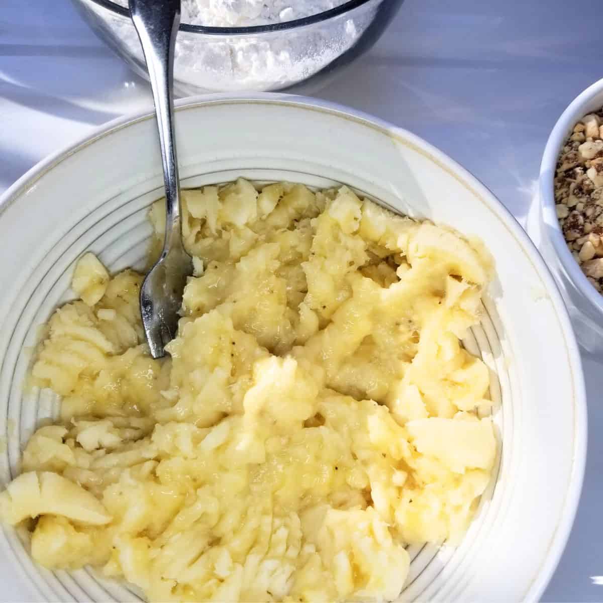 Mashing ripe bananas for homemade banana nut bread batter.