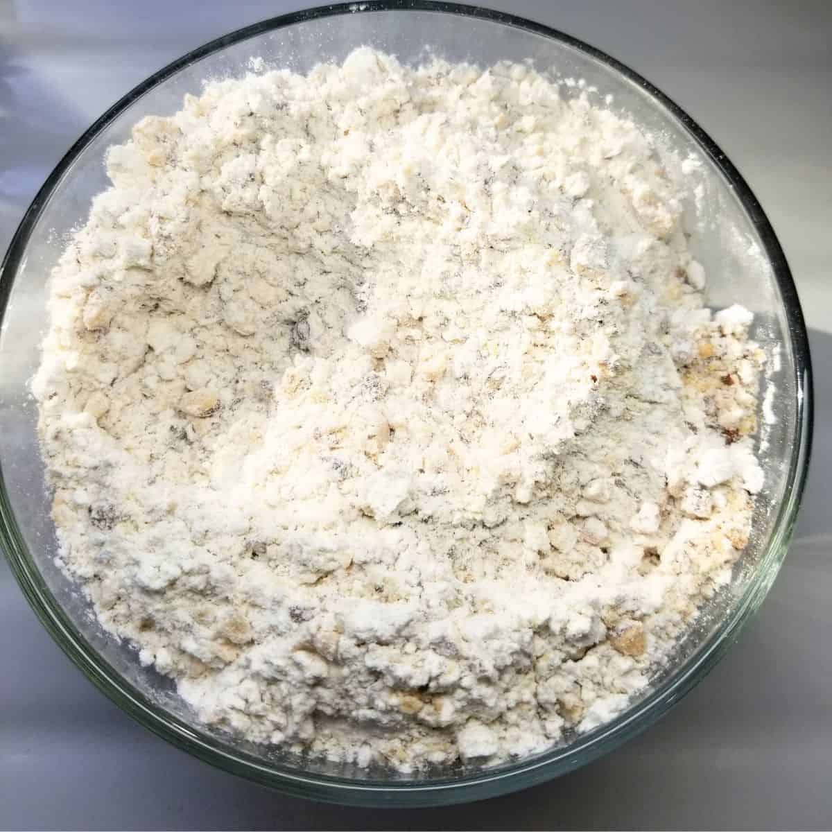 Sifting the dry ingredients in a bowl and stirring in chopped pecans.