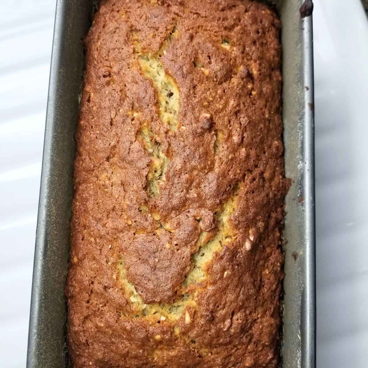 Freshly baked banana nut bread cooling before slicing.