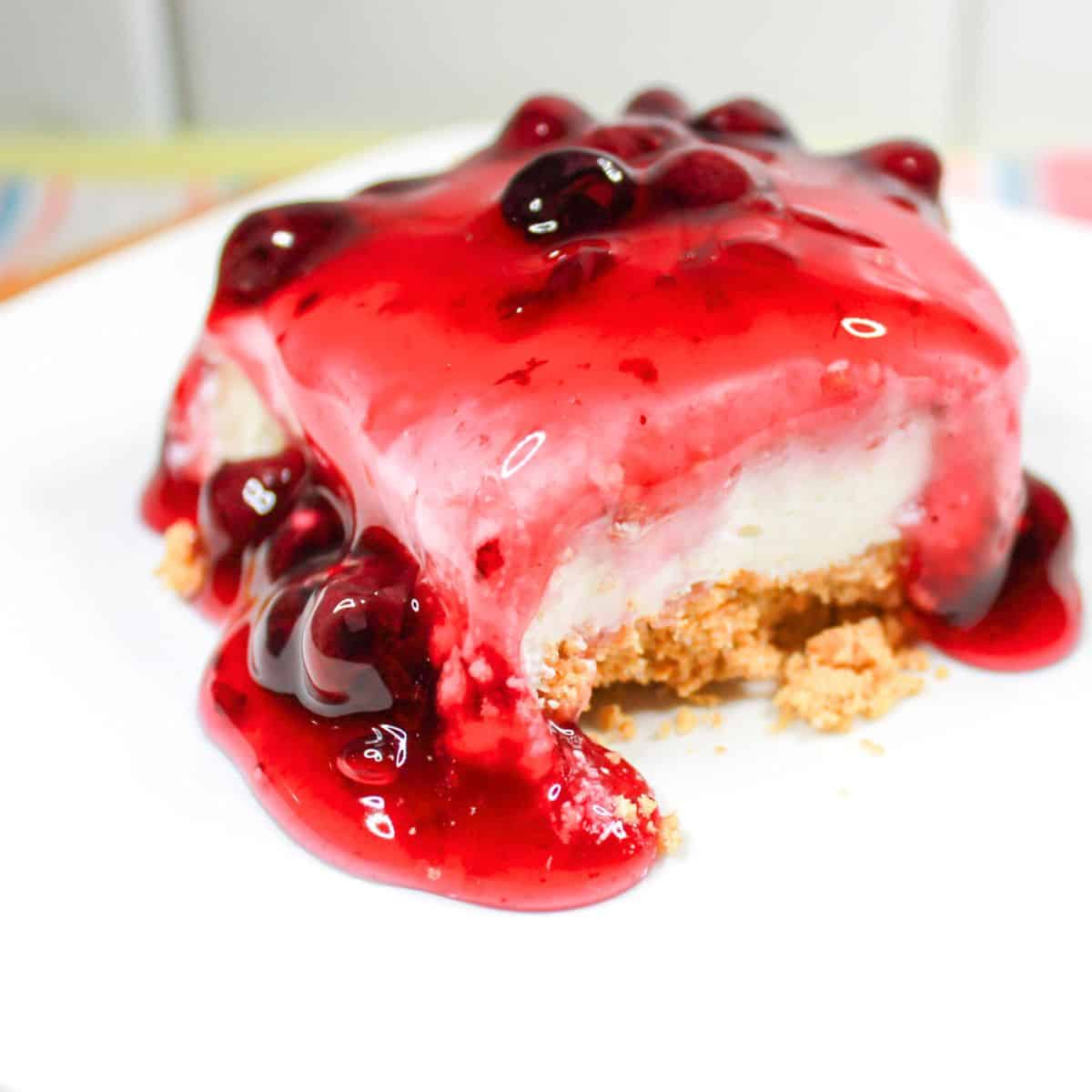 Blueberry cheesecake bar on a white plate.