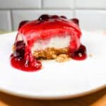 Blueberry cheesecake bar on a white plate.