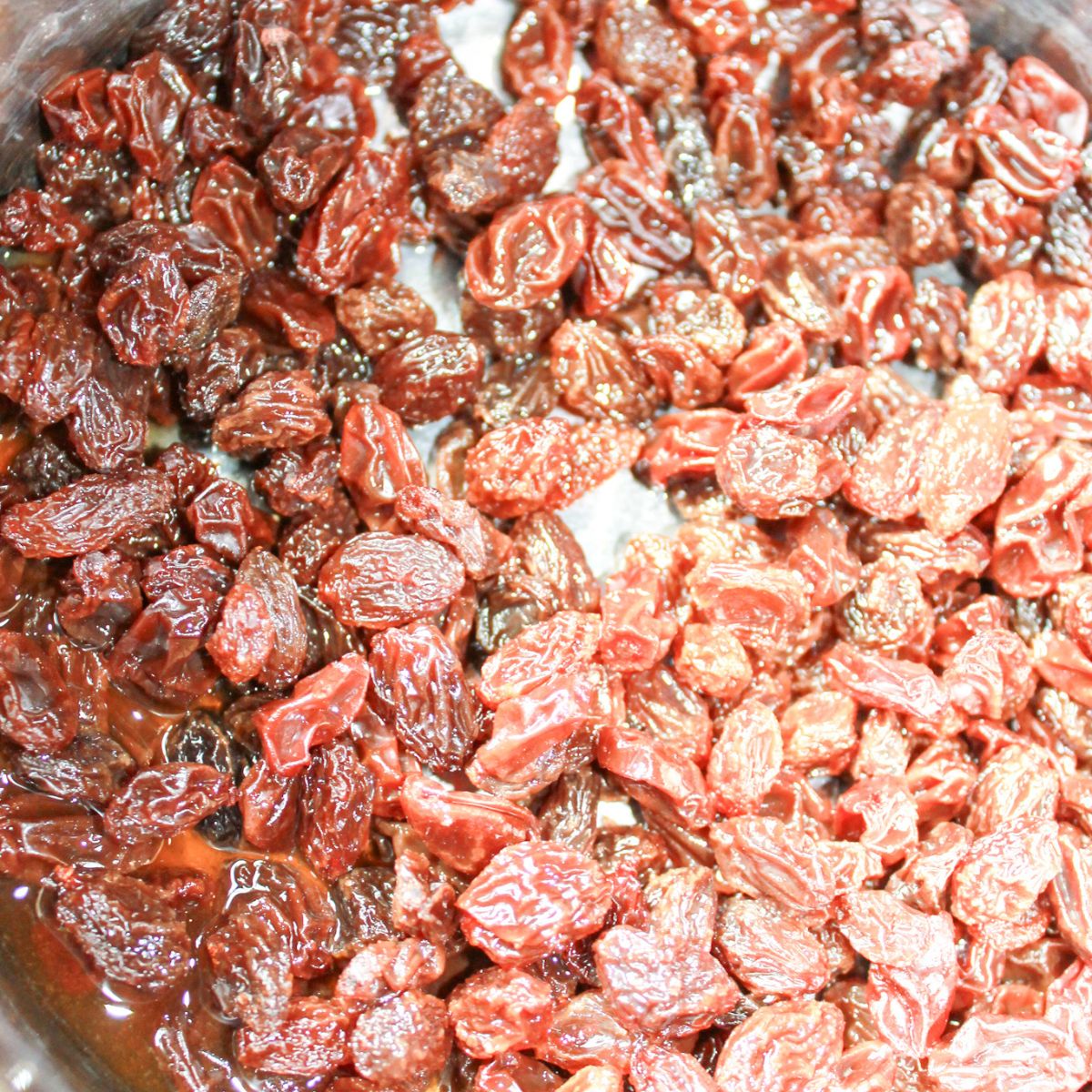 Raisins soaking in bourbon in a small saucepan.