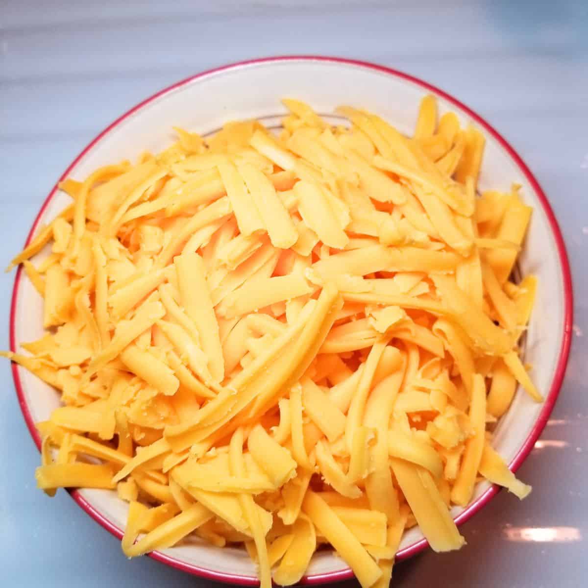 Add shredded cheese to the soup.