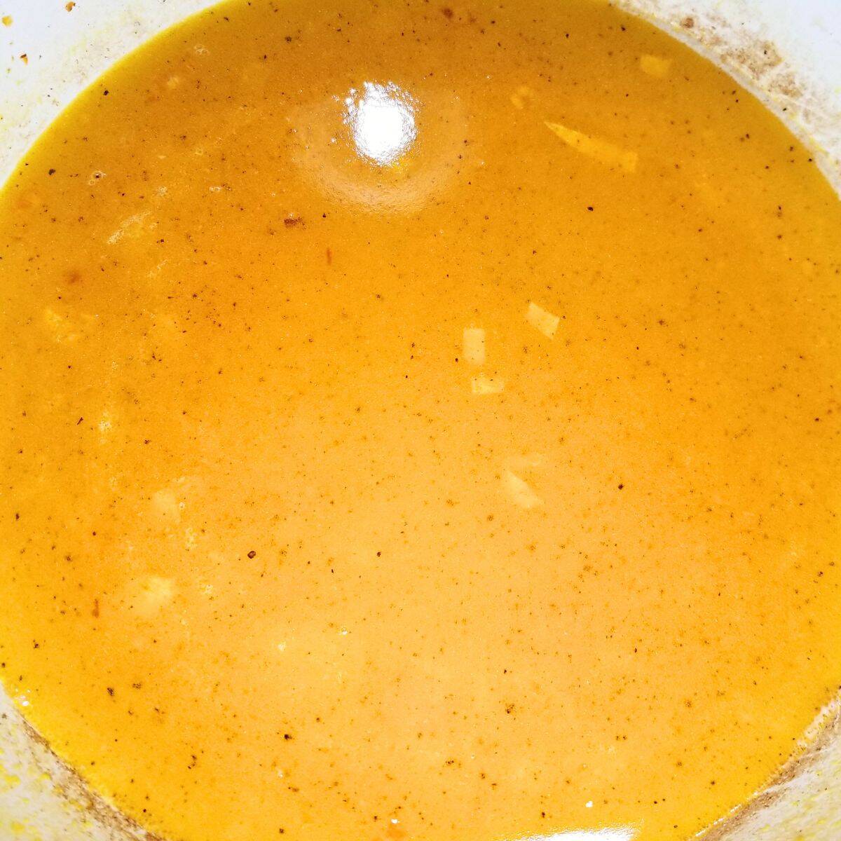 Broth and seasonings added to the soup pot.