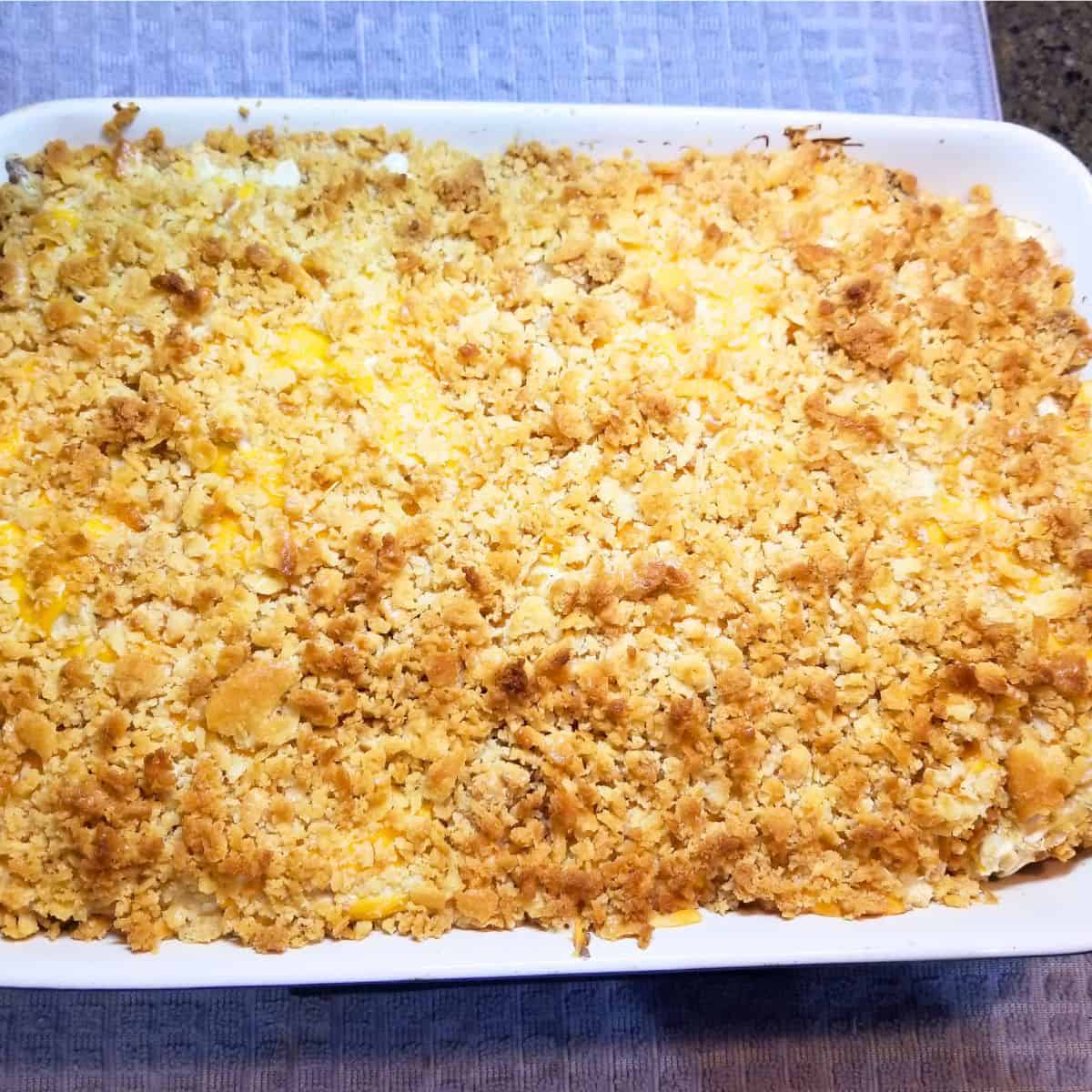 Close-up of creamy chicken broccoli casserole with melted cheese and crunchy Ritz topping.