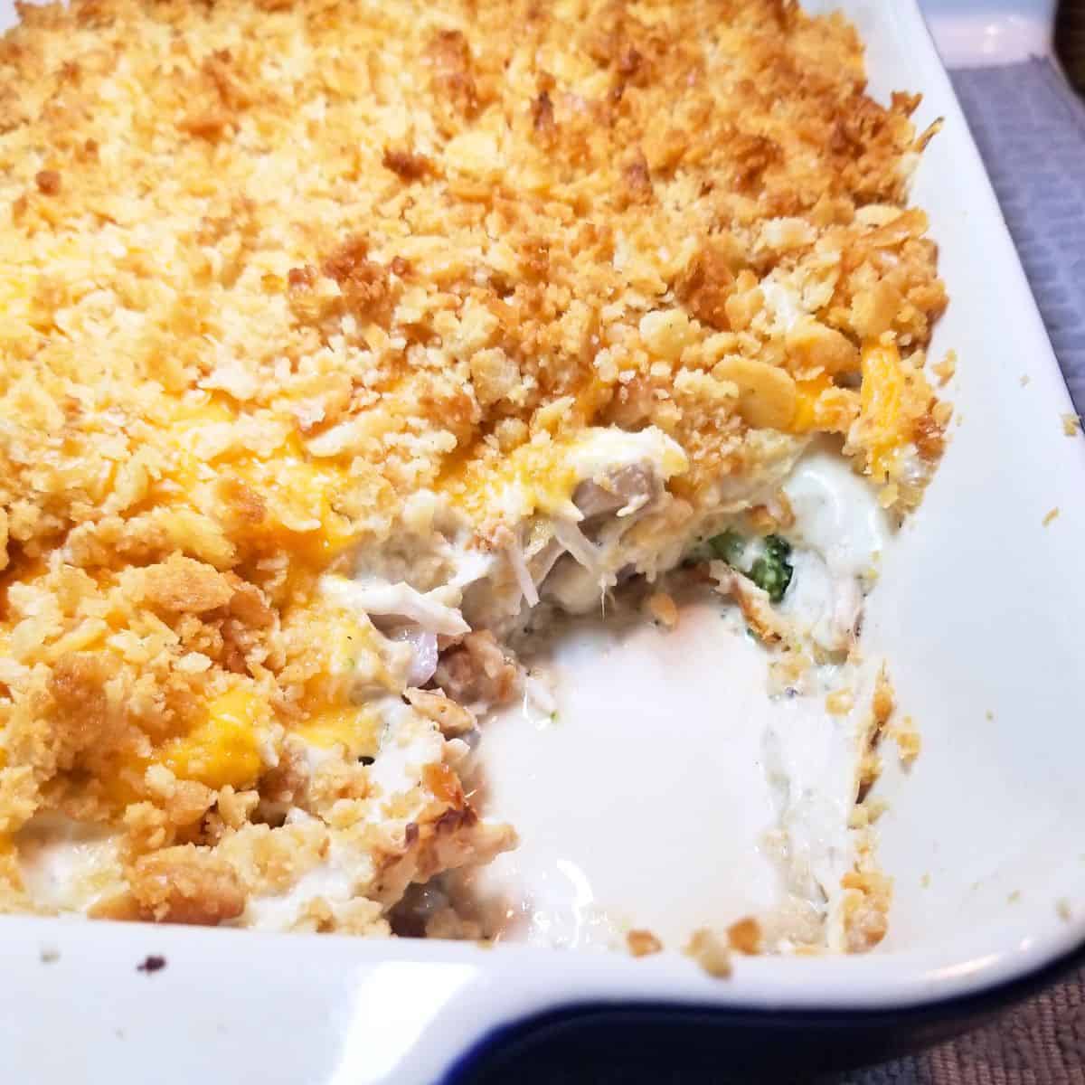Baked chicken casserole sliced with visible broccoli, chicken, and mushrooms.