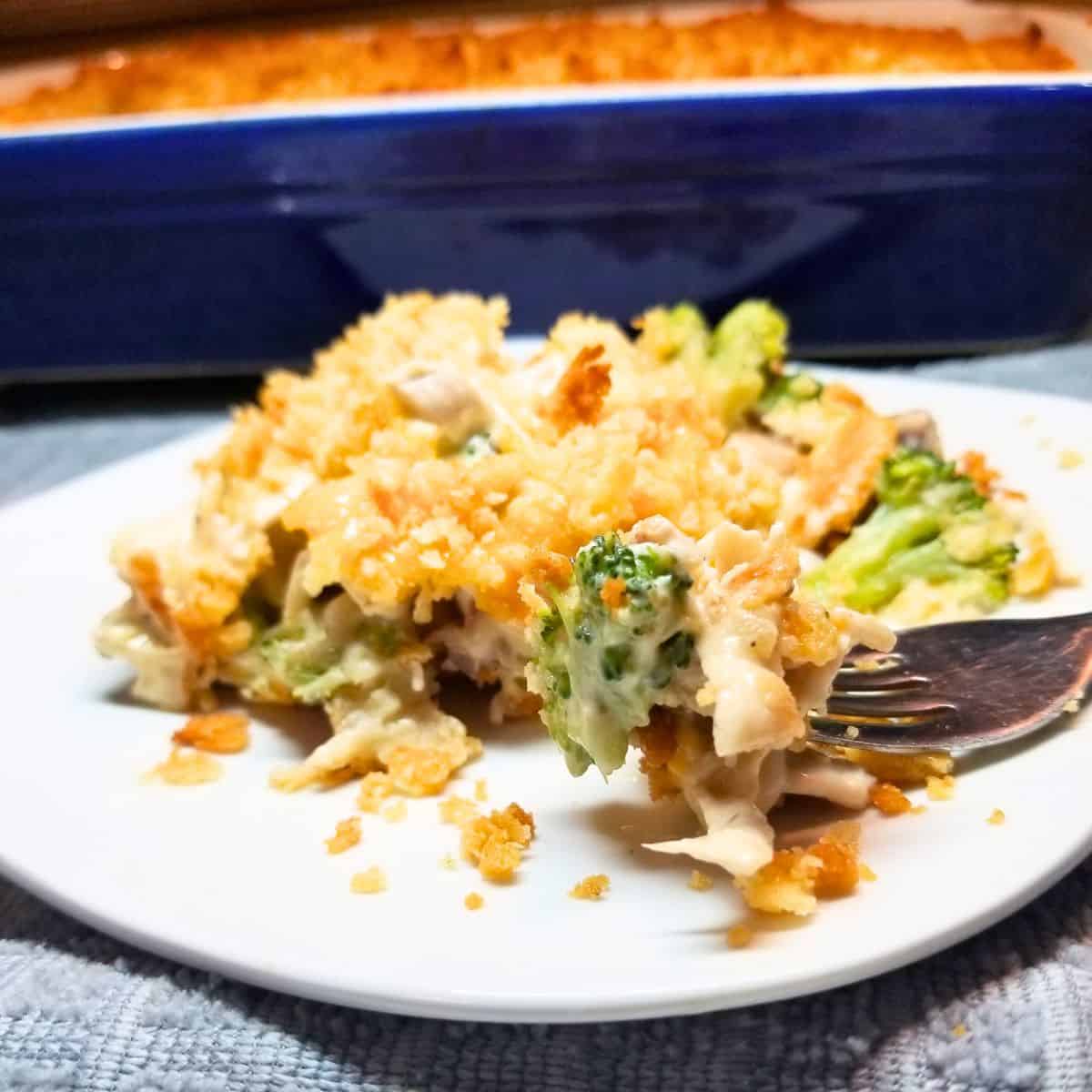 Chicken and broccoli casserole on a white plate.