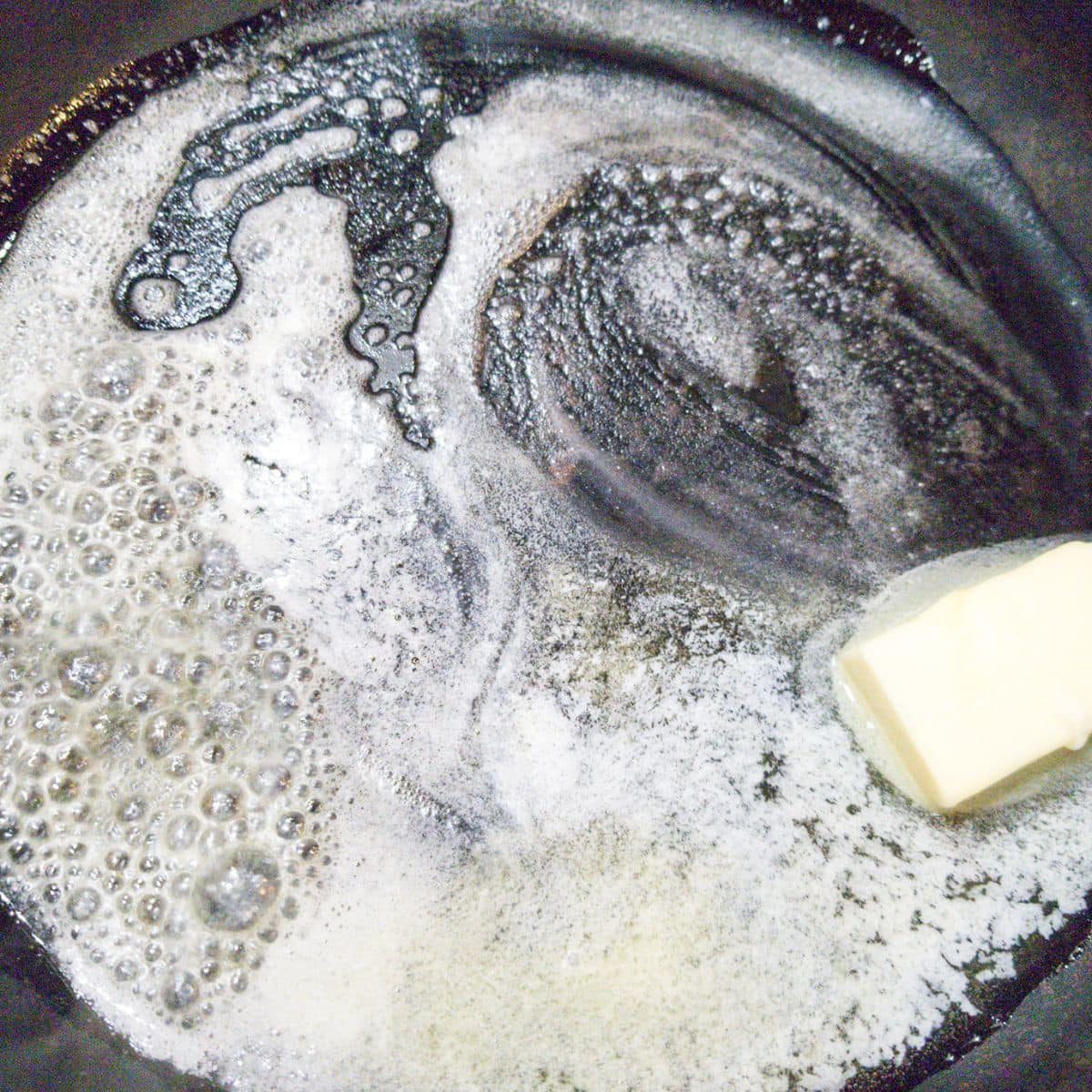 Melting butter in a cast iron skillet.