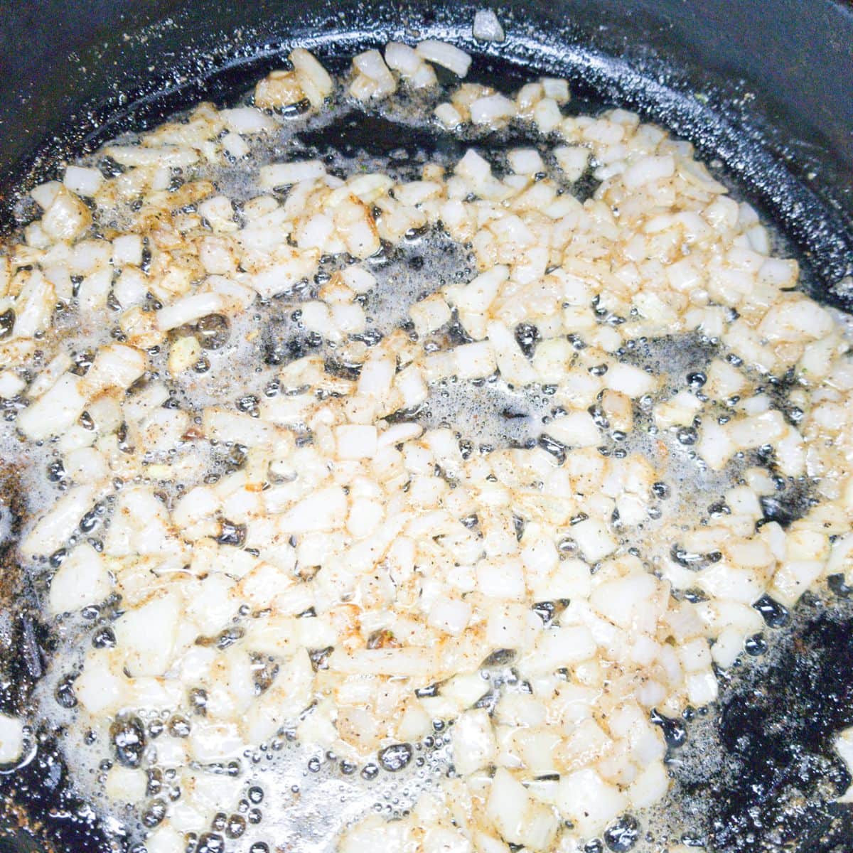 Sauteing onions in a cast iron skillet.