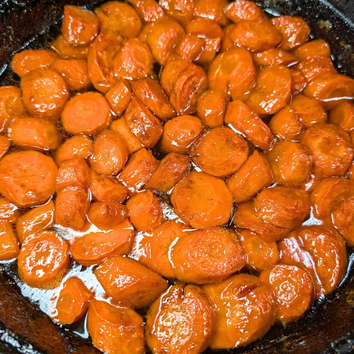 Candied carrots in a cast iron skillet.