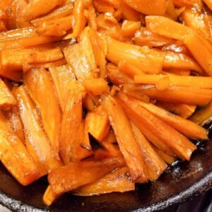 Cooked sweet potatoes in a cast iron skillet.