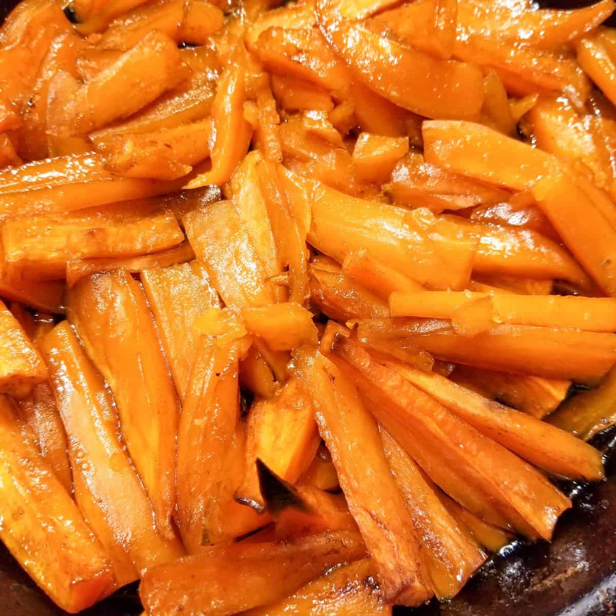 Baked sweet potatoes in a cast iron skillet.
