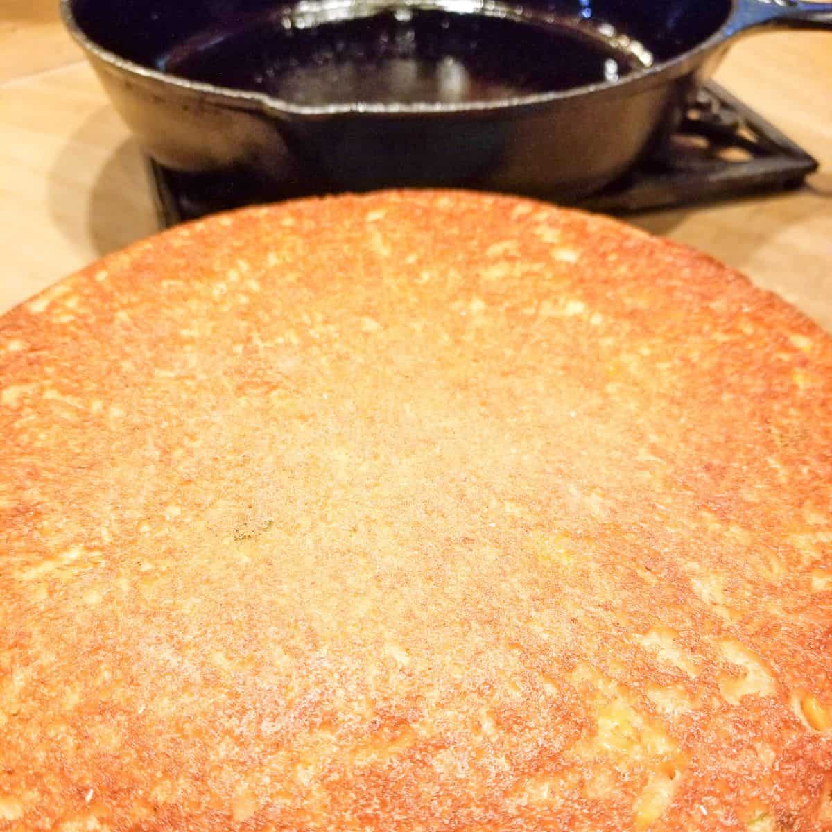 Homemade buttermilk cornbread baked in a cast iron skillet.