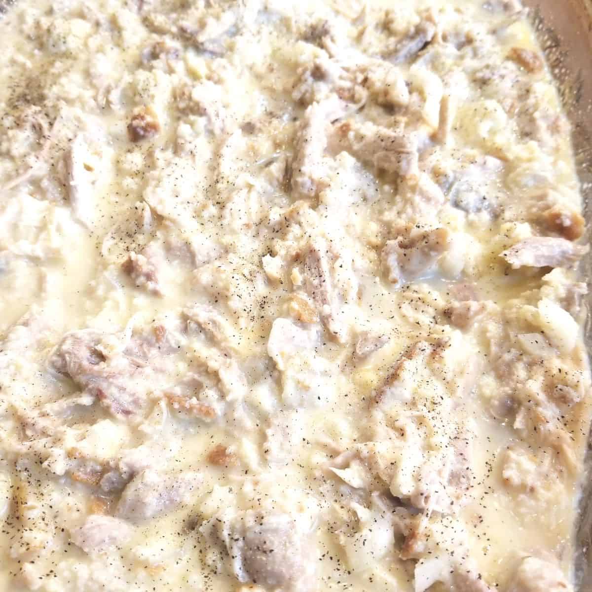 Chicken and Dressing ingredients mixed in a large dish.