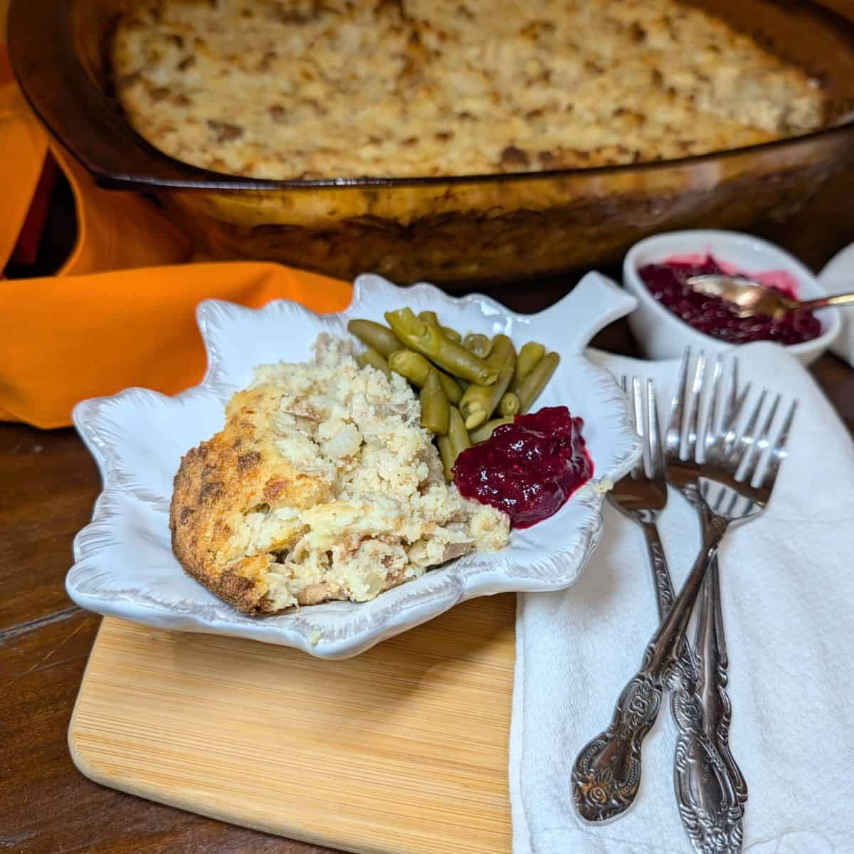 Chicken and Dressing on a a plate and in a baking dish.
