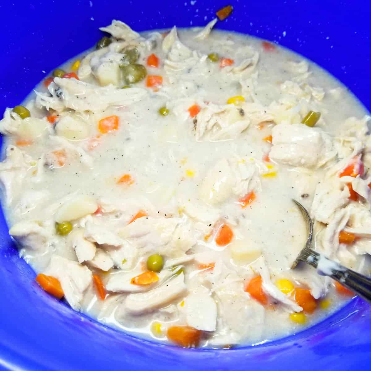 Mixing the pot pie filling in large bowl.