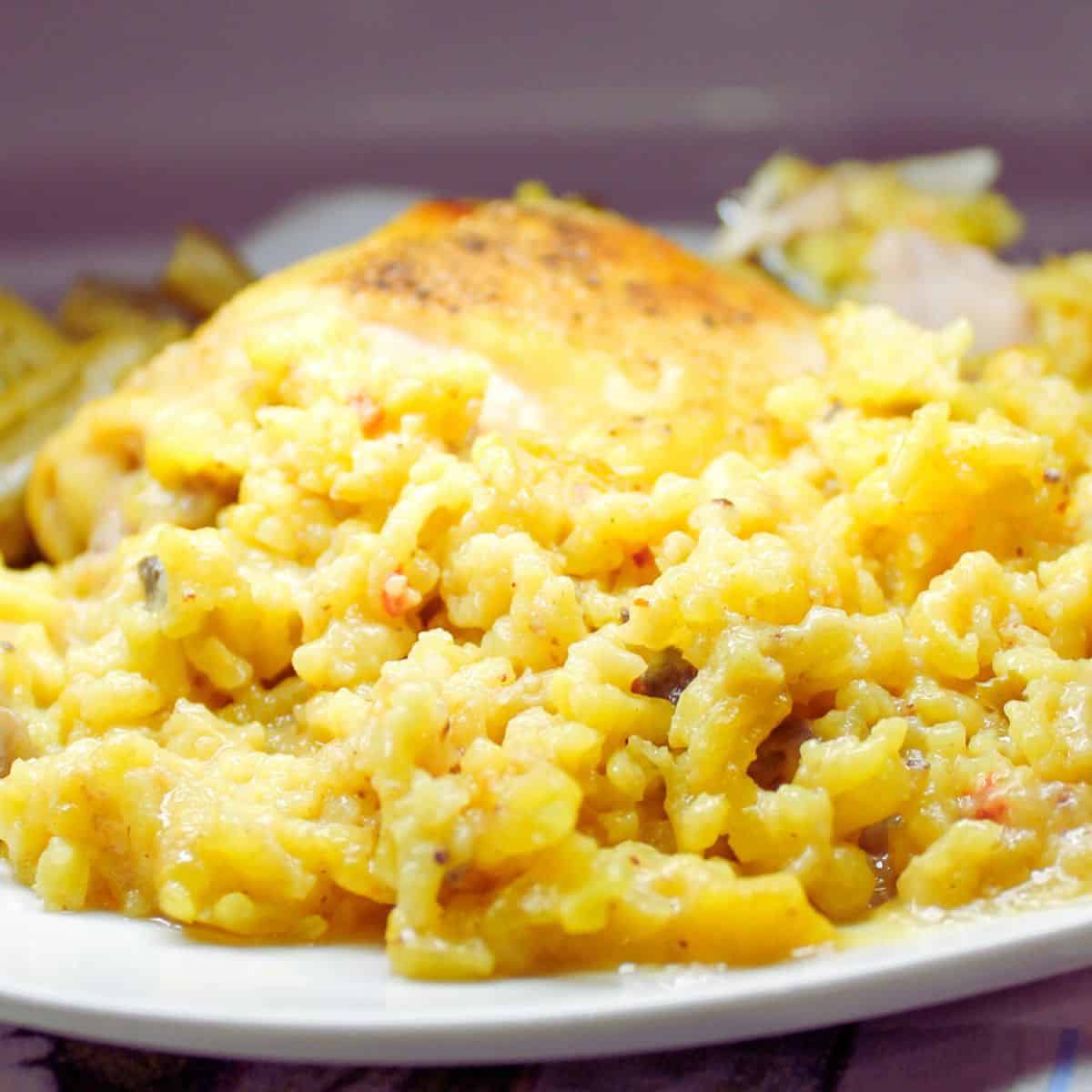 Chicken yellow rice casserole on a white plate.