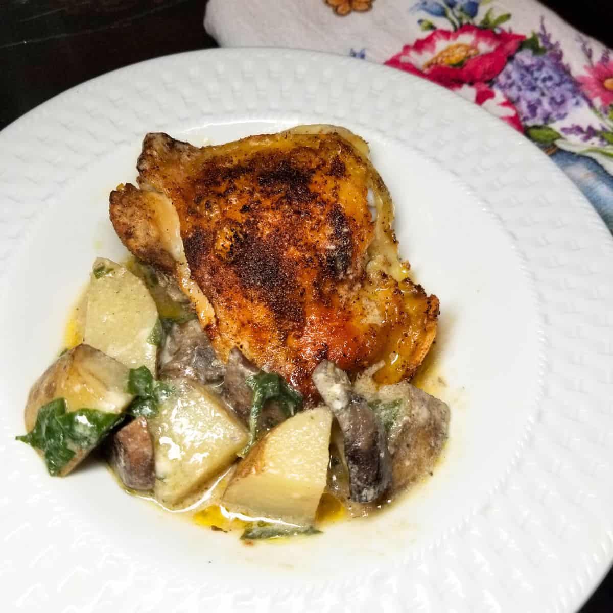 Chicken and Potatoes cooked and ready to eat in a white bowl.