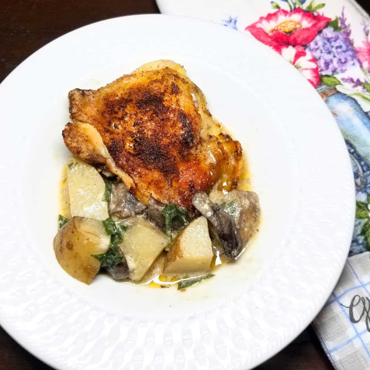 Chicken with potatoes in a serving bowl.