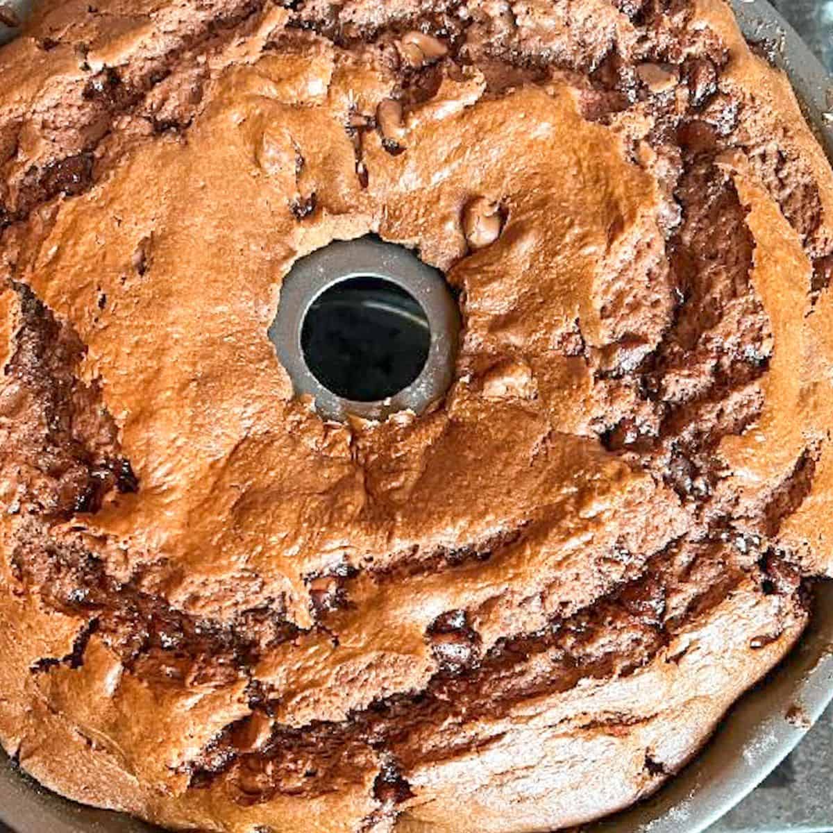 Cooked chocolate pudding cake in a Bundt pan cooling.