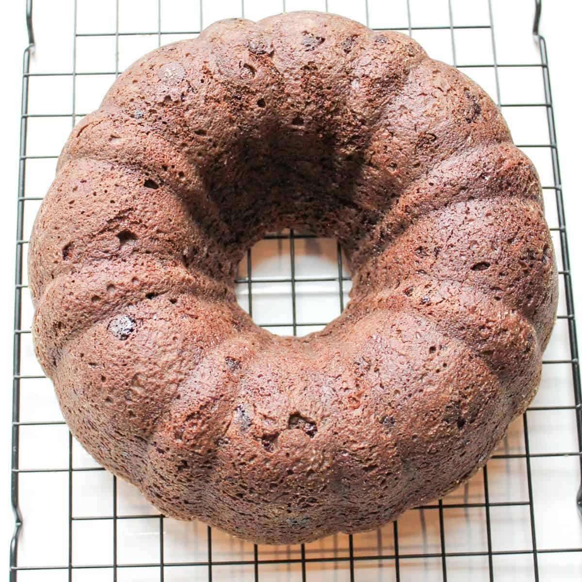 The finished chocolate Bundt cake cooling on a wire rack.