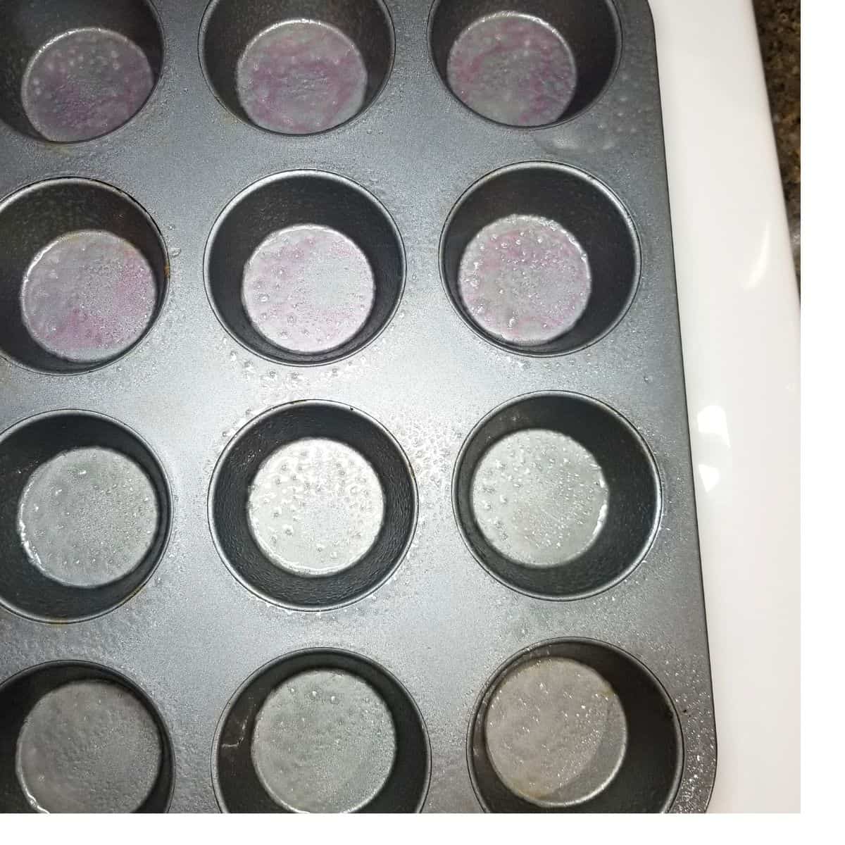 Muffin tin sprayed with oil.