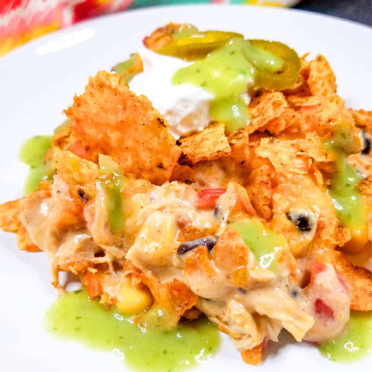 Dorito chicken casserole on a white serving plate.