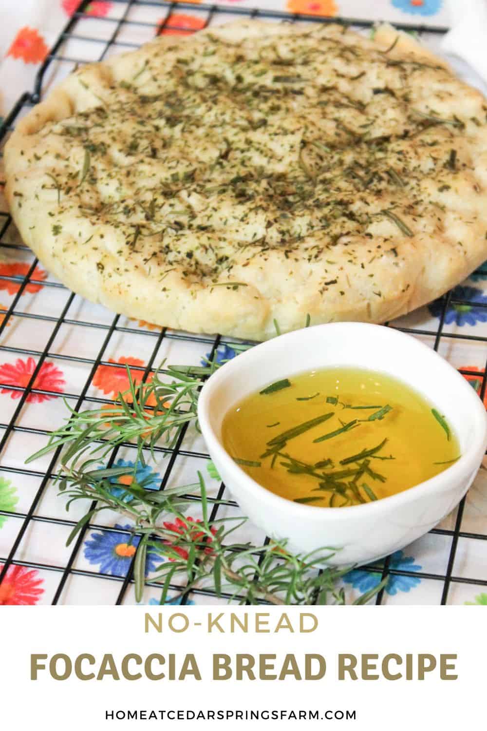 Focaccia bread on a cooling rack with olive oil in a white bowl with text overlay.