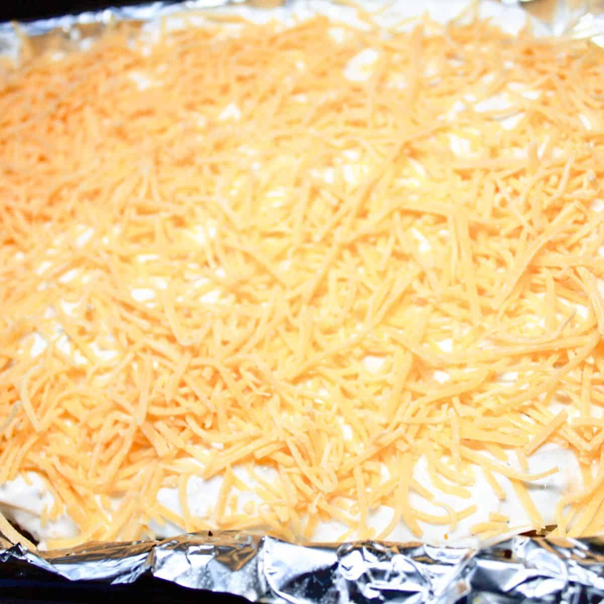 French onion chicken topped with shredded cheese.