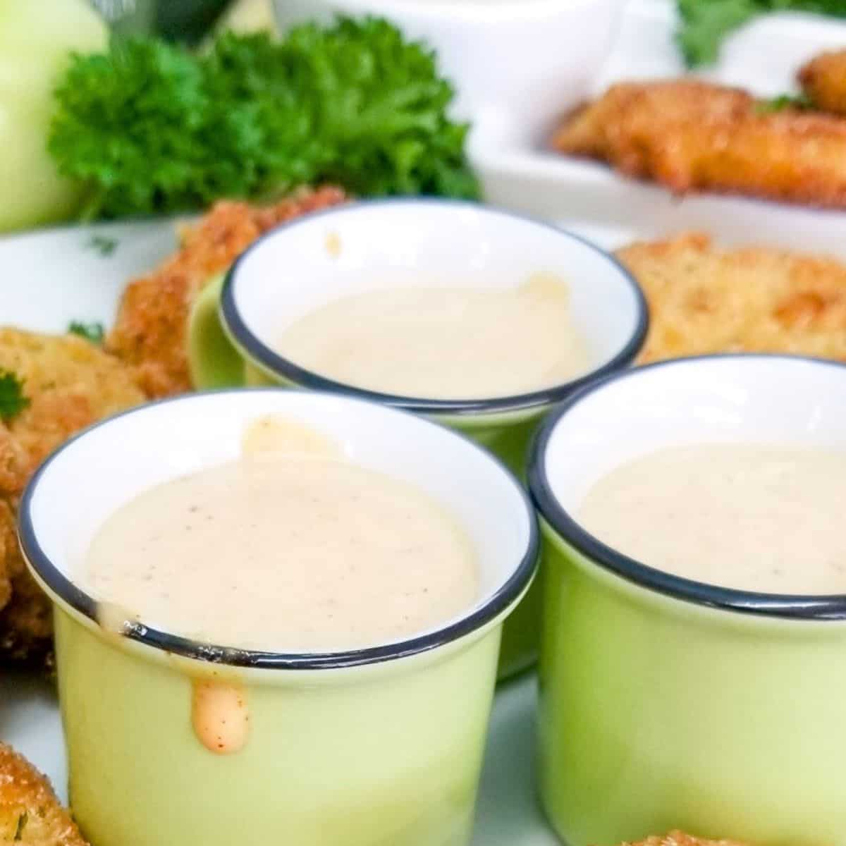 Dipping sauce in little green bowls.
