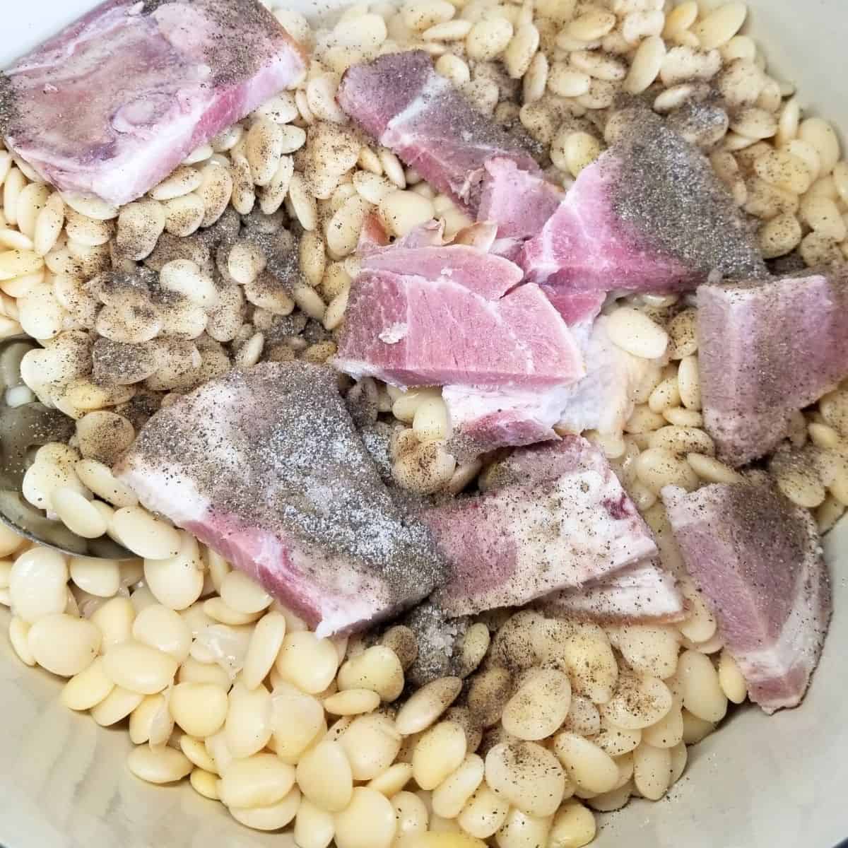 All of the ingredients added to a big pot on the stove ready to be cooked.