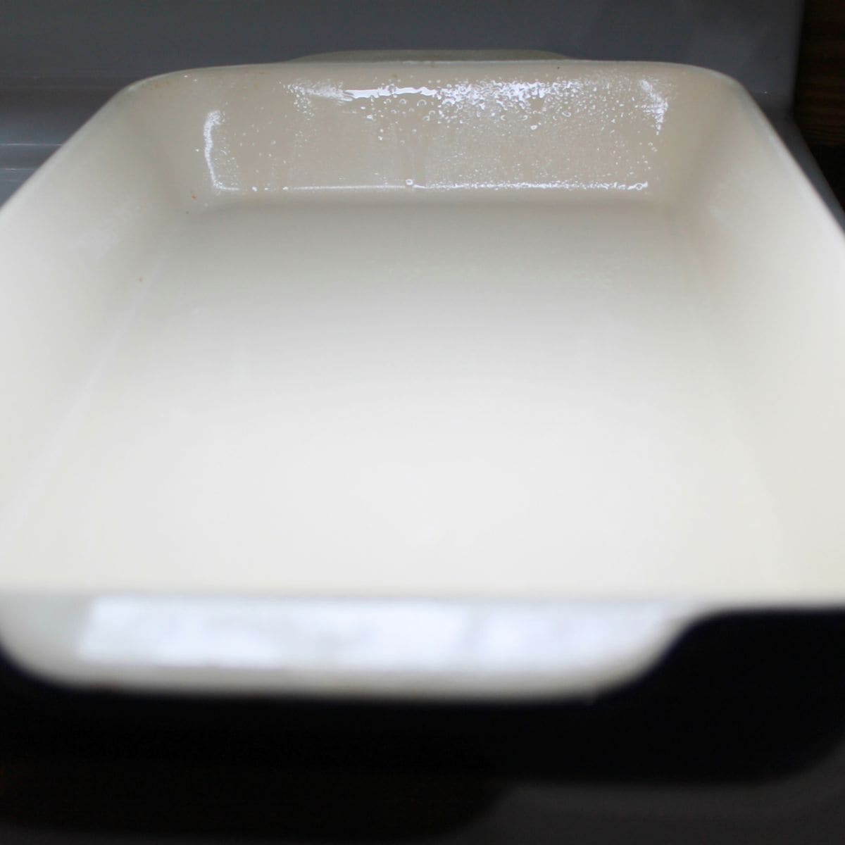 A casserole dish sprayed with cooking spray.