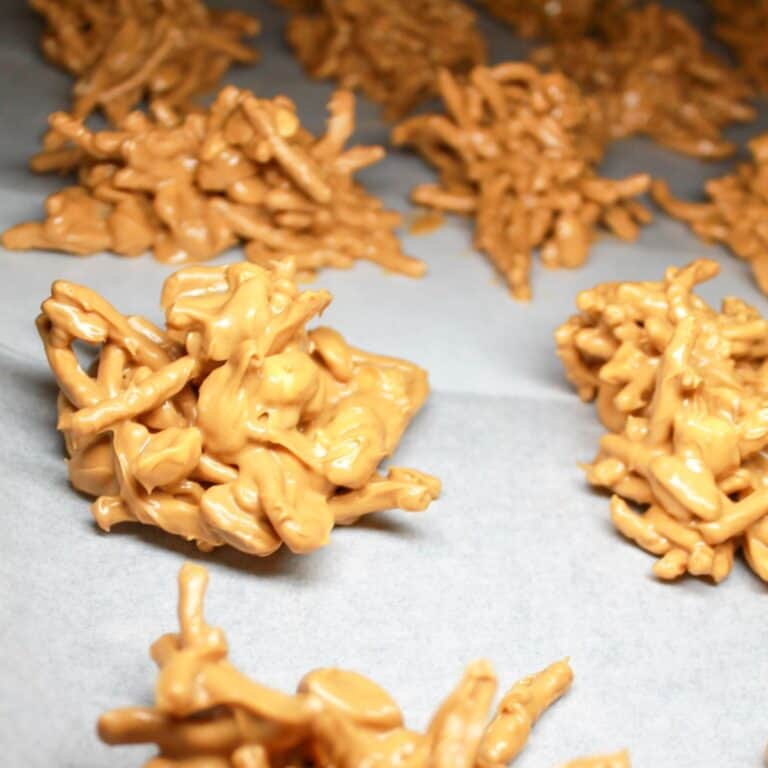 Peanut butter haystacks on white parchment paper.