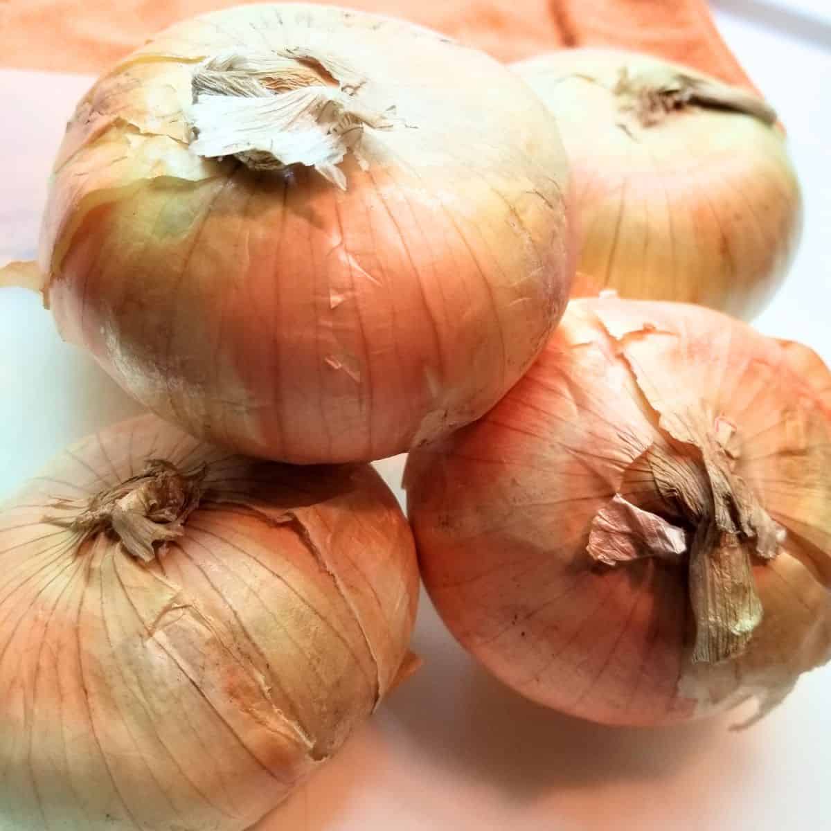 Picture of whole onions stacked on top of each other.