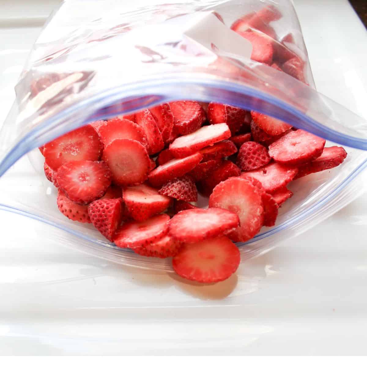 Frozen sliced strawberries in a zip top bag.