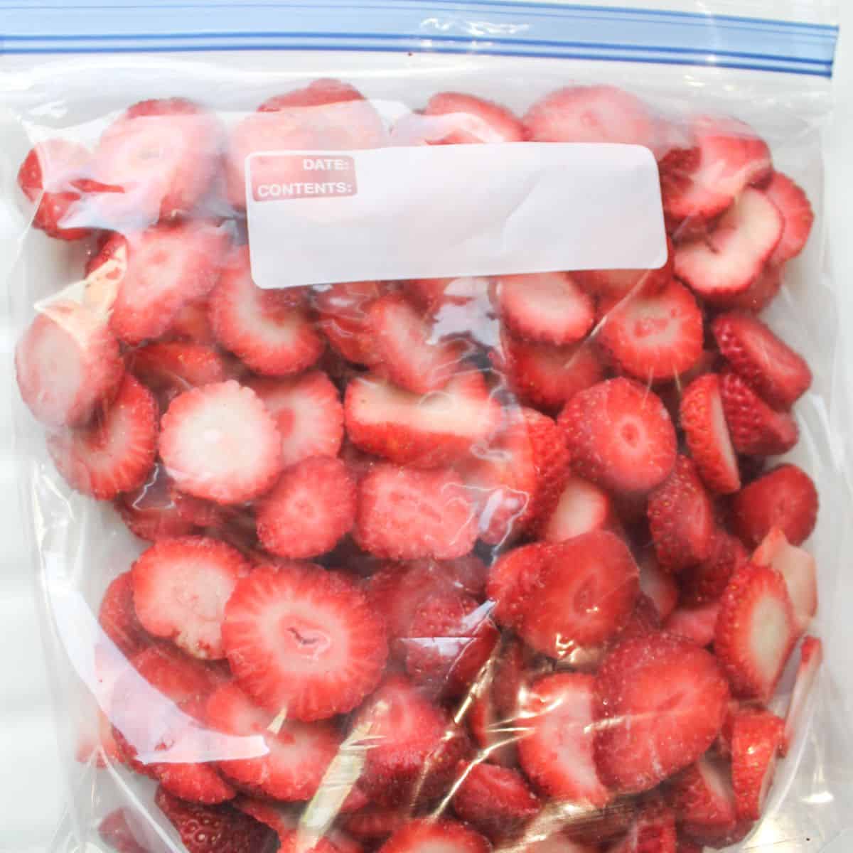 Frozen strawberries in a zip top bag.