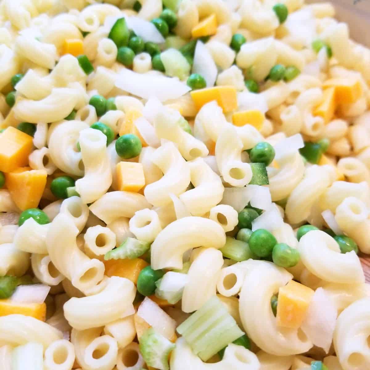 Ingredients mixed in a bowl for macaroni salad.