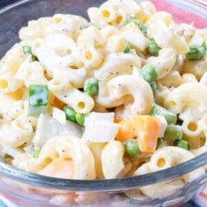 Old fashioned Southern macaroni salad with peas and cheese in a serving bowl.