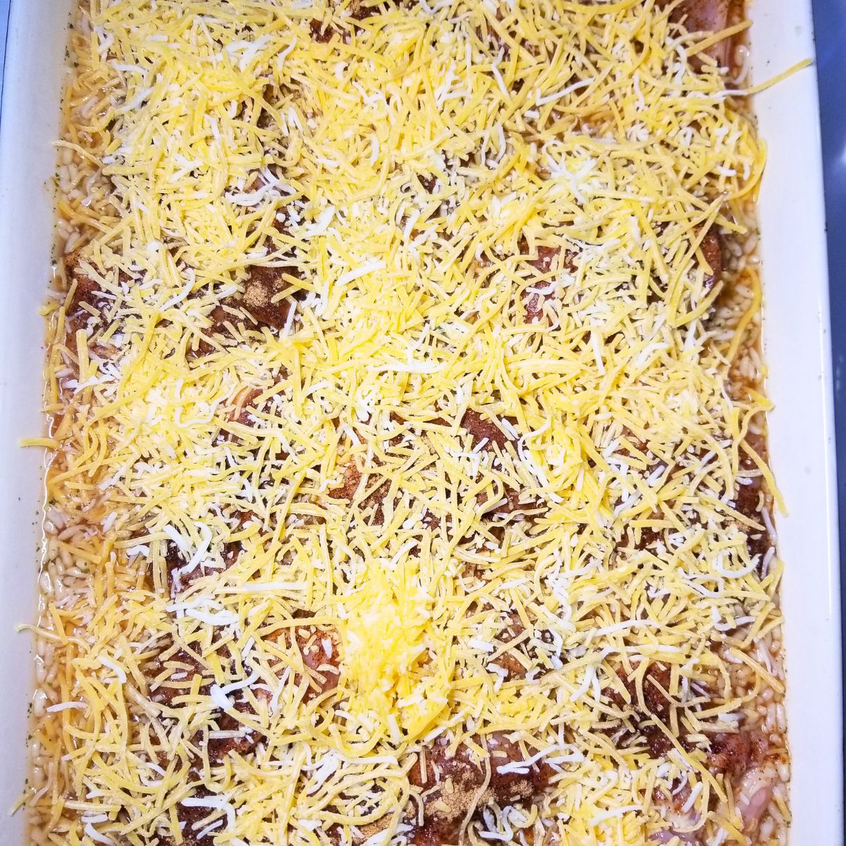 The assembled cheesy Tex-Mex chicken and rice bake ready for the oven.