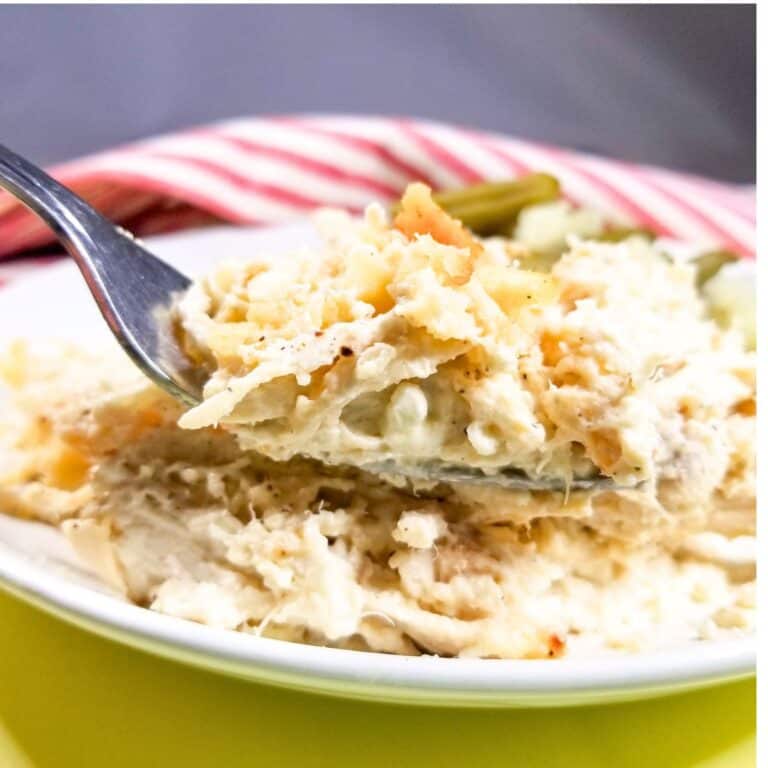 Chicken casserole on a white plate with a fork.