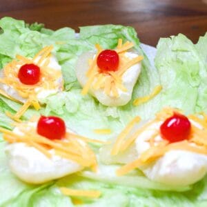 Pear salad on a plate with lettuce leaves.