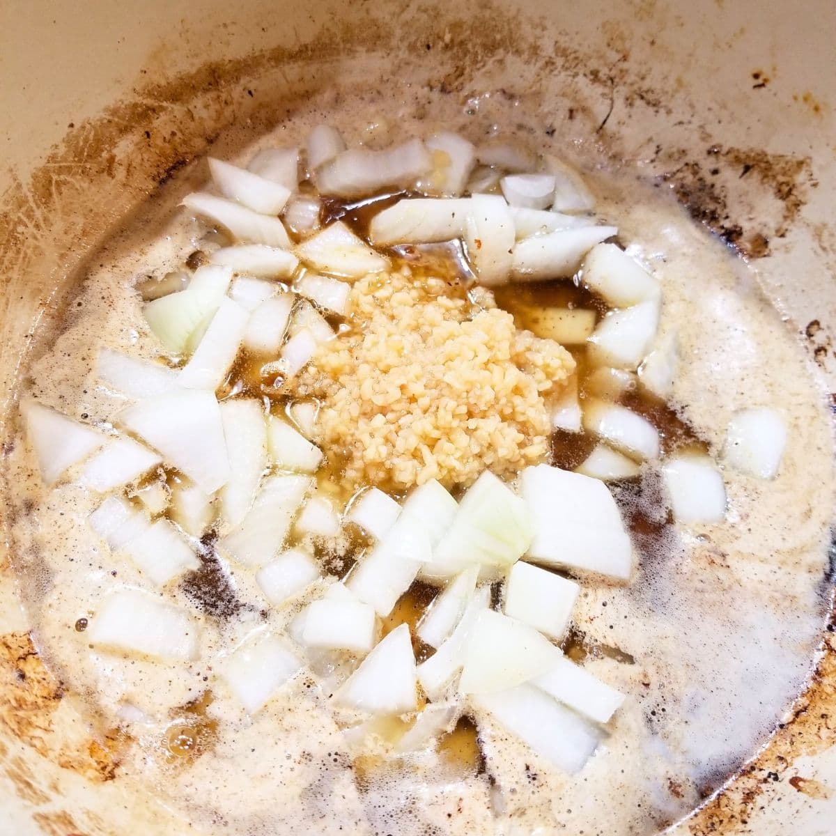 Cooking onions and garlic in a soup pot.