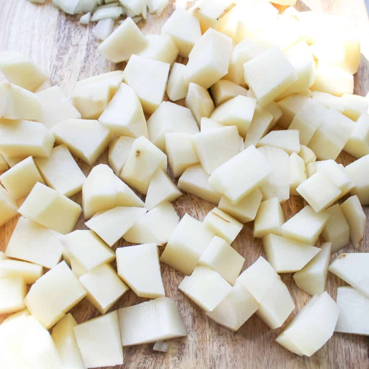 Diced potatoes on a cutting board.