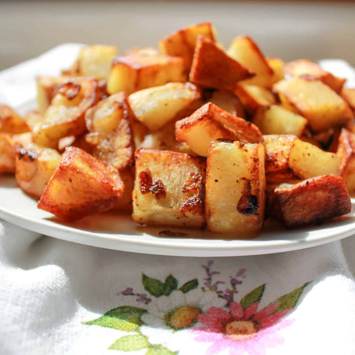 Fried Potatoes and Onions in a white bowl.