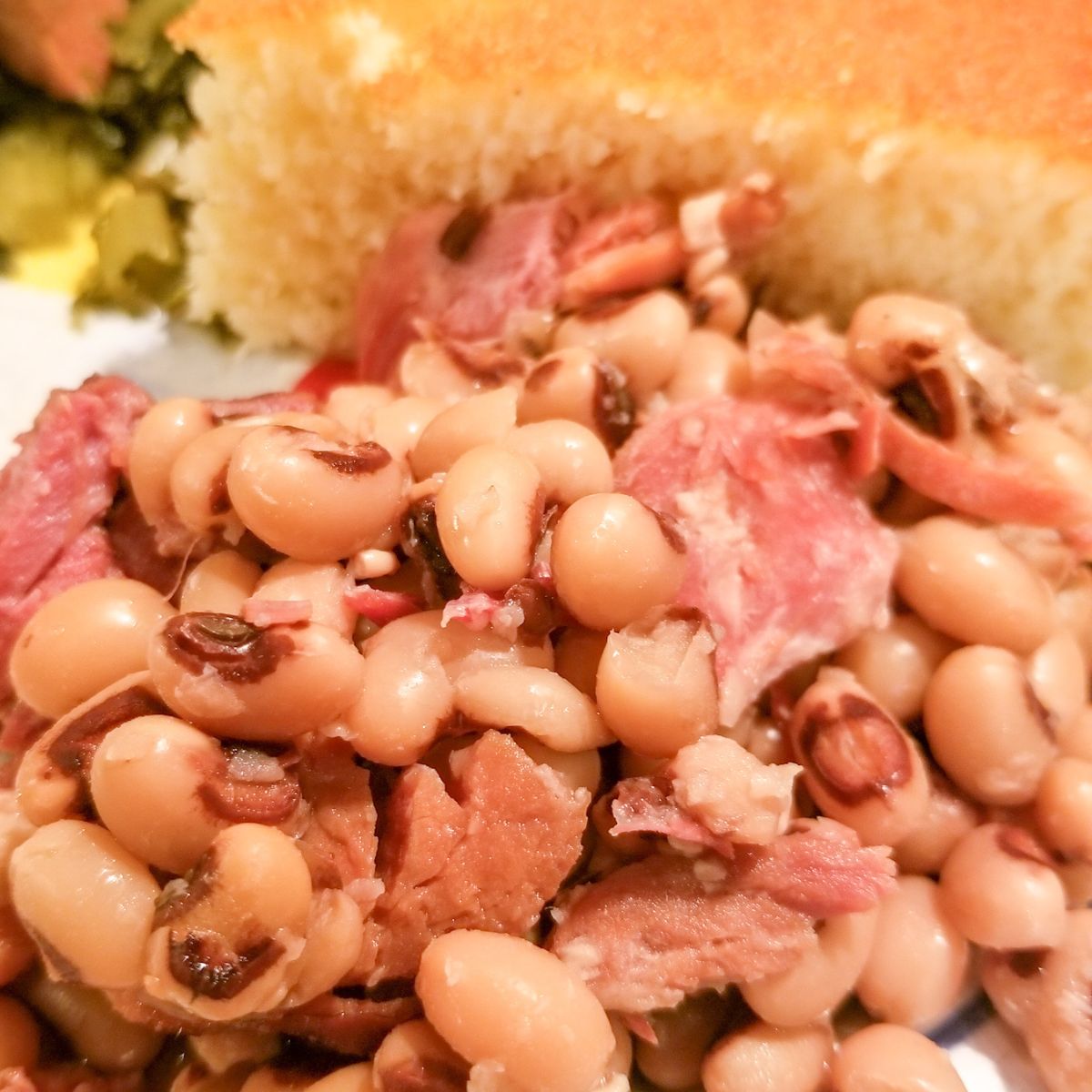 Purple Hull Peas on a plate with cornbread.